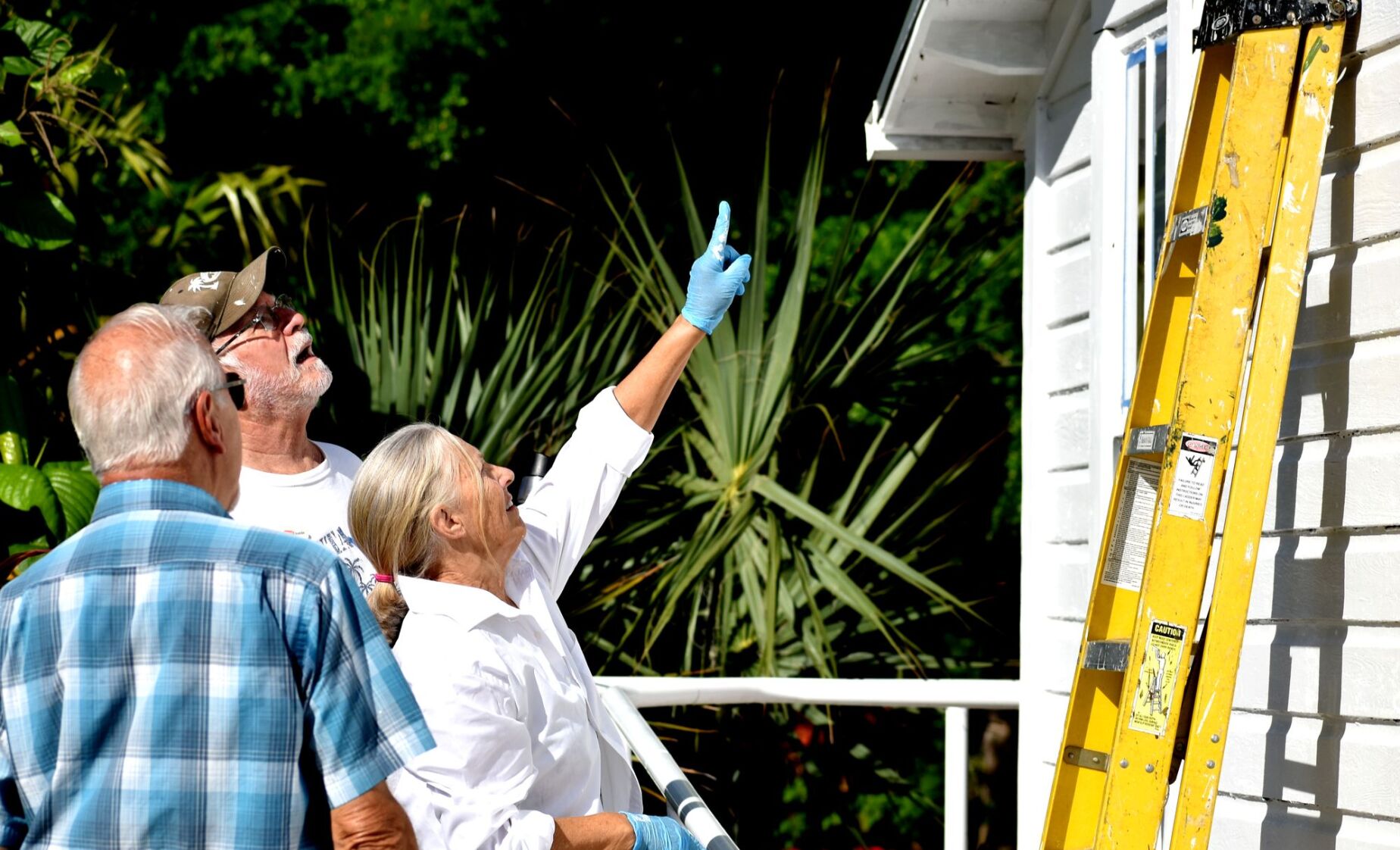 Volunteers paint historic Cigar Cottage at History Park